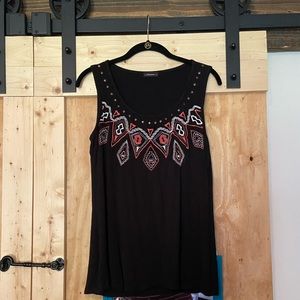 Black tank top with pink and white embroidery.